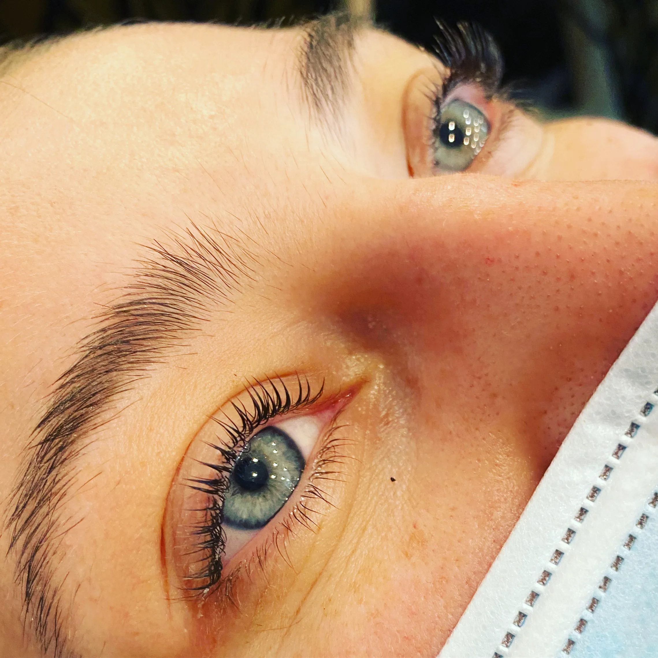 Blue-grey eyes after a lash lift, viewed from above