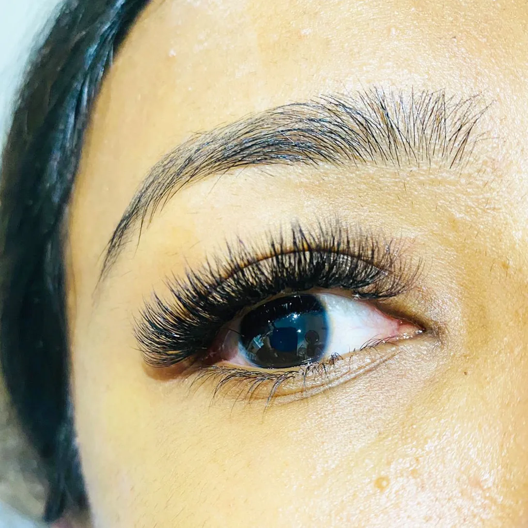 Single eye in tight close-up with a dense fanned classic lash set