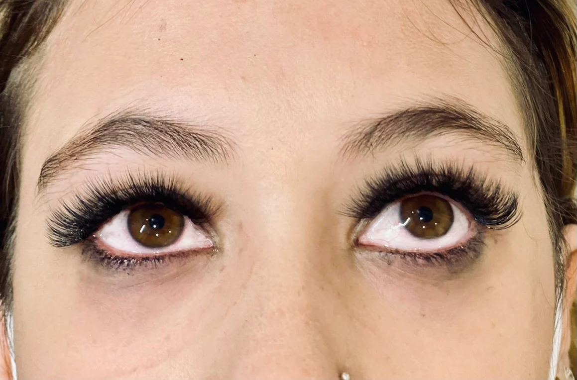 Dense wispy lash extensions on brown eyes